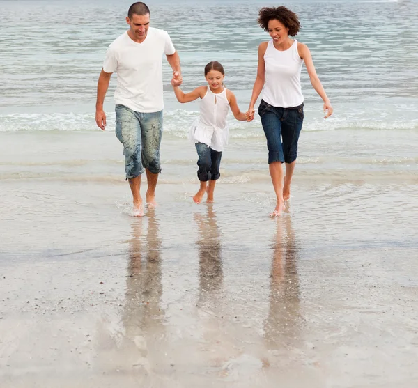 Família caminhando em uma praia — Fotografia de Stock