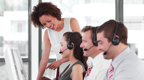 Cheerful business partners working with their manager — Stock Photo, Image