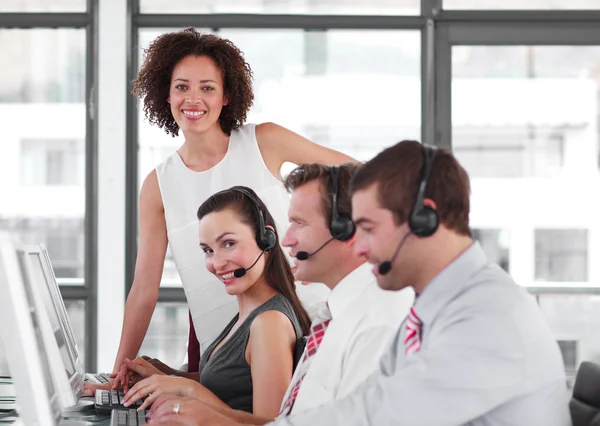 Lächelnde Geschäftspartner arbeiten mit ihrem Manager zusammen — Stockfoto