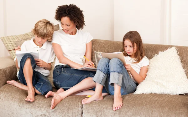 Charming family sitting on a sofa — Stock Photo, Image