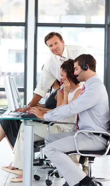 Senior manager in a call center looking at the camera — Stock Photo, Image