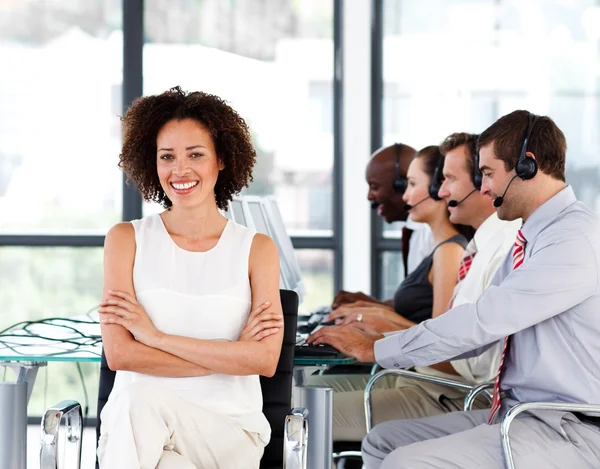 Smiling female manager working in a call center — Stock Photo, Image