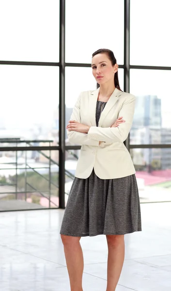 Beautiful businesswoman with folded arms — Stock Photo, Image