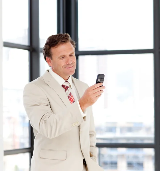 Empresario enviando un mensaje en su celular — Foto de Stock
