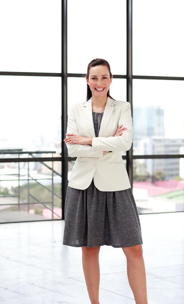 Beautiful smiling businesswoman with folded arms — Stock Photo, Image