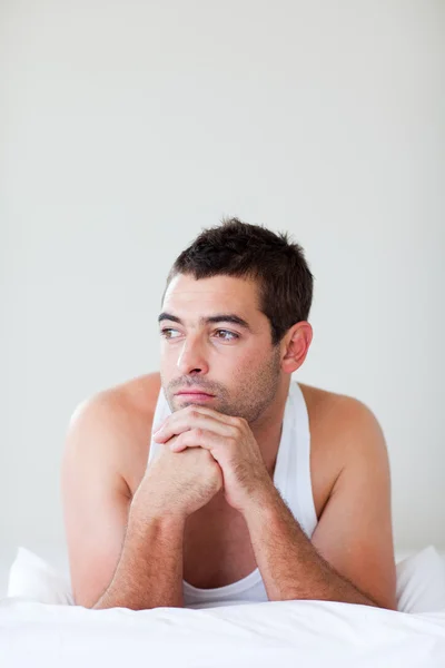 Attractive man lying in bed — Stock Photo, Image