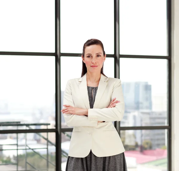 Beautiful businesswoman with folded arms — Stock Photo, Image