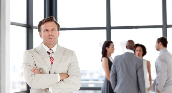 Charming businessman being Positive with team in Background — Stock Photo, Image