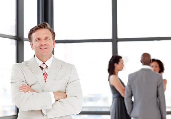 Charming businessman being Positive with team in Background — Stock Photo, Image