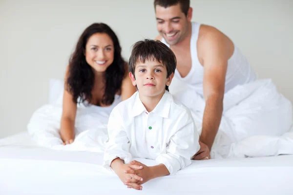 stock image Young couple and son playing in bed