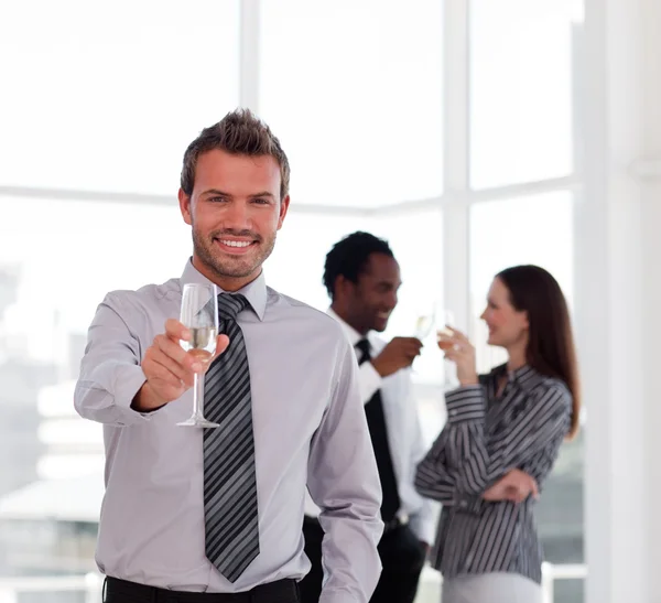 Happy businessman celebrating a success with champgane — Stock Photo, Image
