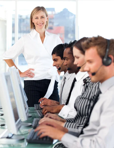 Concentrated female leader with a team on a call center — Stock Photo, Image