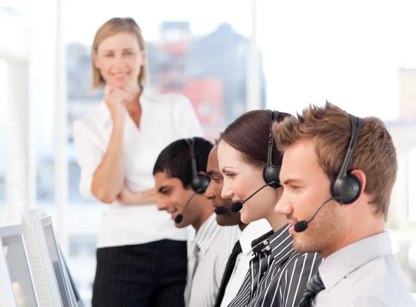 Concentrated female leader with a team on a call center — Stock Photo, Image