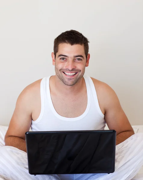 젊은 남자가 그의 침실에서 노트북을 사용 하 여 — 스톡 사진