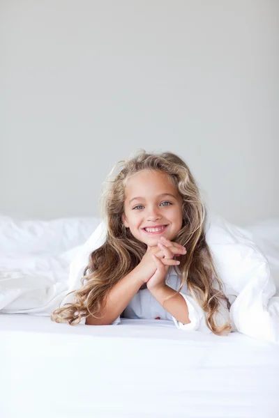 Mooi meisje op haar bed — Stockfoto
