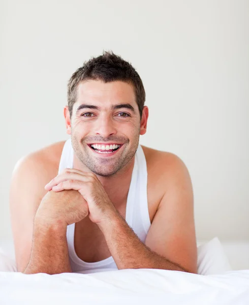 Lächelnder Mann im Bett — Stockfoto