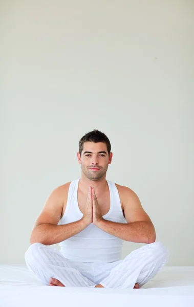 Człowiek siedzi na łóżku medytacji z lekkoatletka — Zdjęcie stockowe