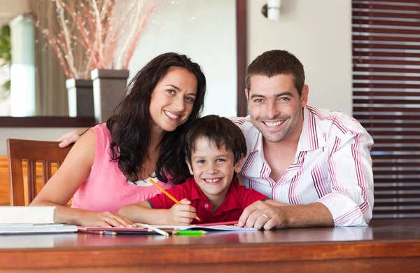 Lovely couple helping his son for homework — Stock Photo, Image