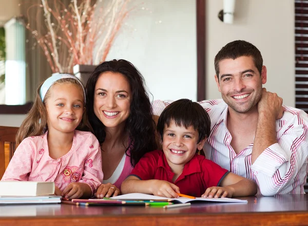 Nice parents helping their children for homework — Stock Photo, Image