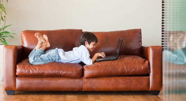 stock image Young kid playing with a laptop