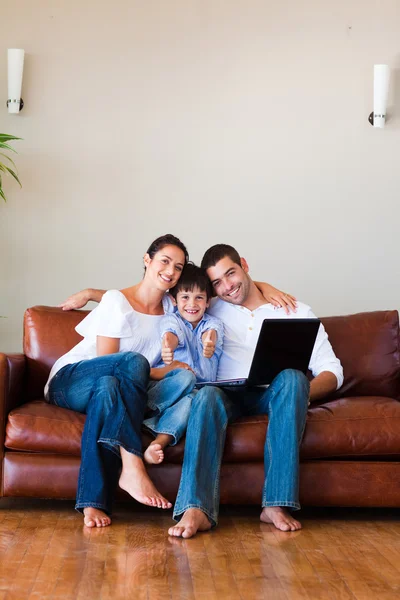 Family using a laptop with thumbs up and copy-space — Stock Photo, Image
