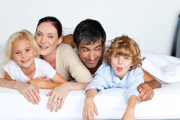 Happy family together on bed — Stock Photo, Image