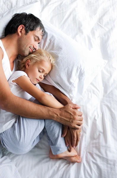 Dad and little girl sleeping on bed — Stock Photo, Image