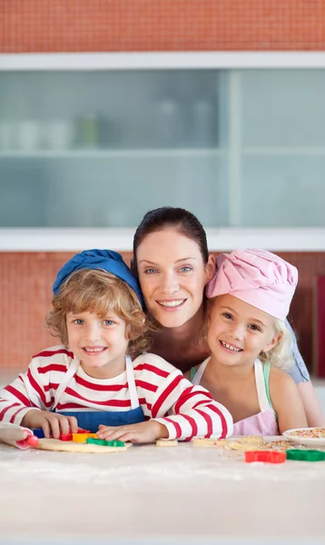 Vreugdevolle moeder bakken met haar kinderen — Stockfoto