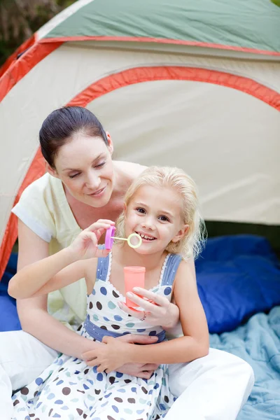 Mother and daughter together in tent — Stock Photo, Image