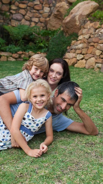 Lachende familie rusten in een tuin — Stockfoto
