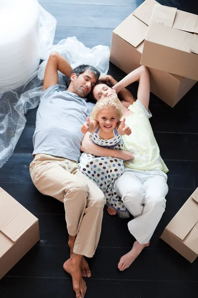 Parents and daughter on the floor with thumbs up — Stock Photo, Image