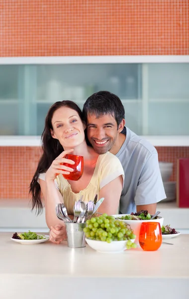 Lovers eating in the kitchen — Stock Photo, Image