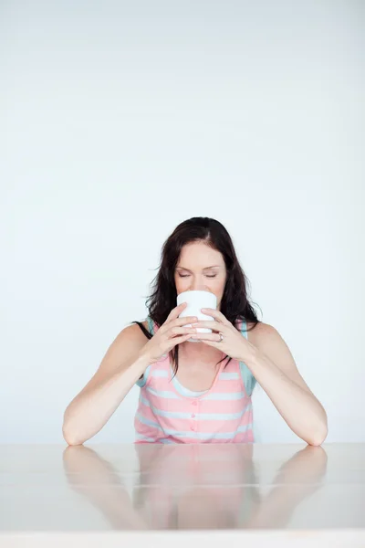 Žena si dává šálek kávy — Stock fotografie