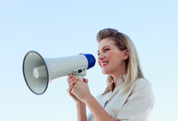 Businesswoman shouting through megaphone — Stock Photo, Image