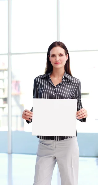 Serious woman showing a big business card — Stock Photo, Image