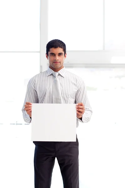 Serious businessman showing a white card — Stock Photo, Image
