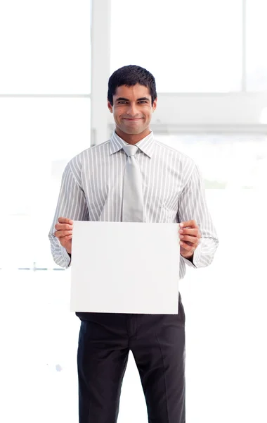 Friendly businessman holding a white card — Stock Photo, Image