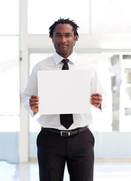Serious Afro-American businessman holding a white card — Stock Photo, Image