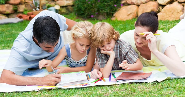 Familia feliz escribiendo en un parque — Foto de Stock