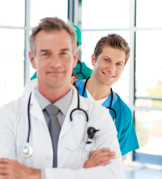 Smiling young doctor in focus in a line — Stock Photo, Image