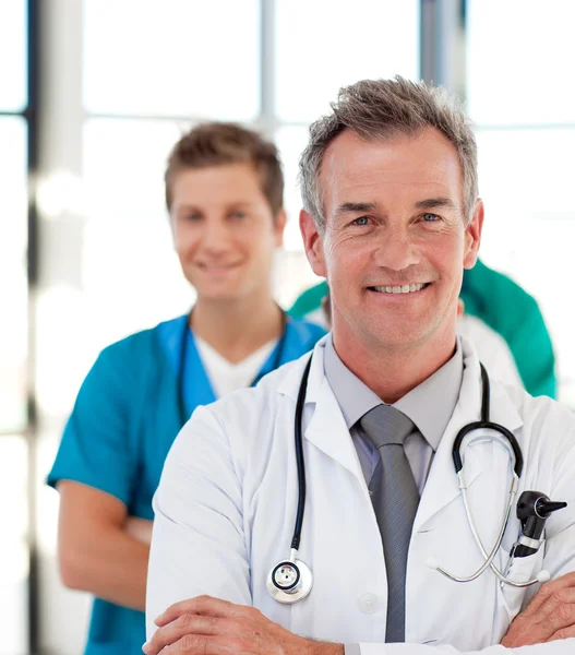 Portrait of a mature doctor leading his team — Stock Photo, Image