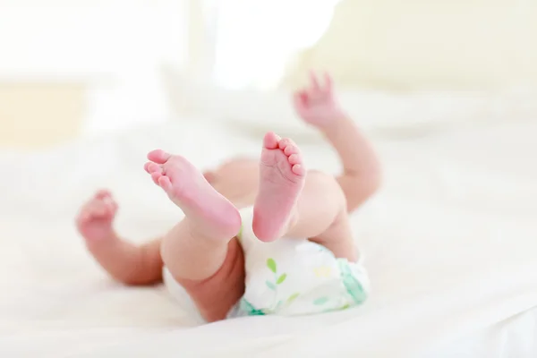 Baby relaxing in bed — Stock Photo, Image