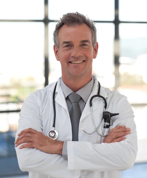 Portrait of a hansdome doctor standing at hospital — Stock Photo, Image