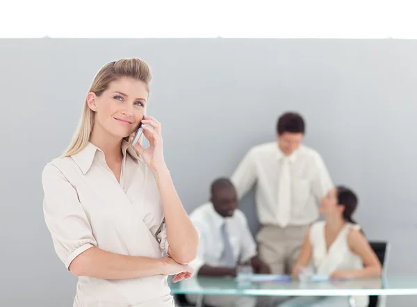 Portrait of businesswoman standing with her collegues — Stock Photo, Image