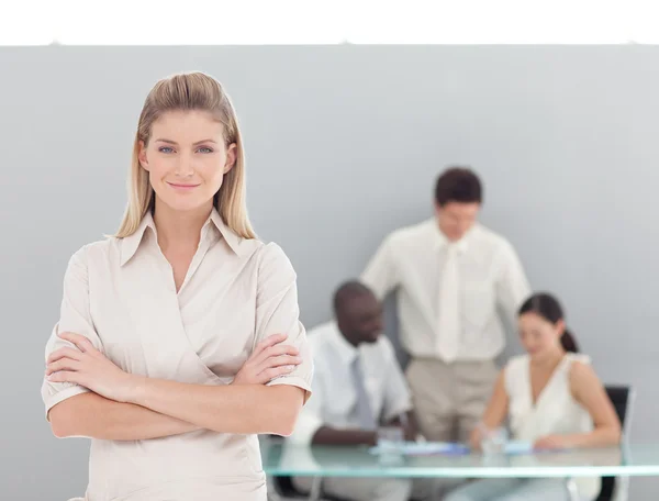 Portrait of a serious businesswoman standing with her collegues — Stock Photo, Image