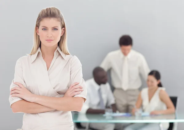 Portrait of a serious businesswoman standing with her collegues — Stock Photo, Image