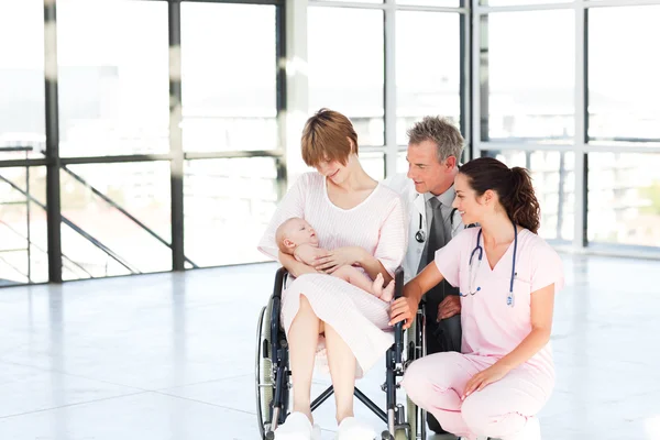 Mother with her newborn baby and doctors with copy-space — Stock Photo, Image