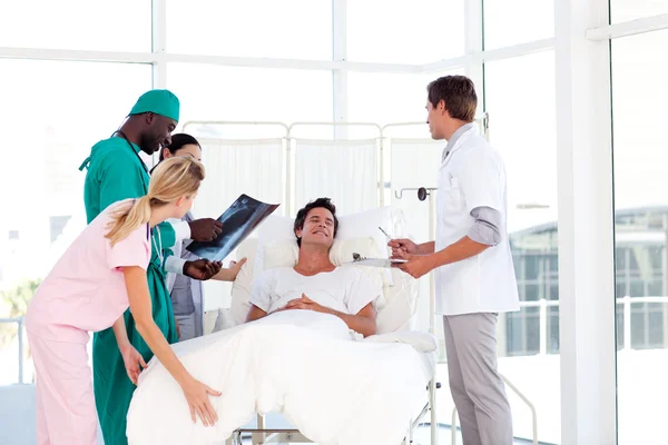Doctors caring to a patient — Stockfoto
