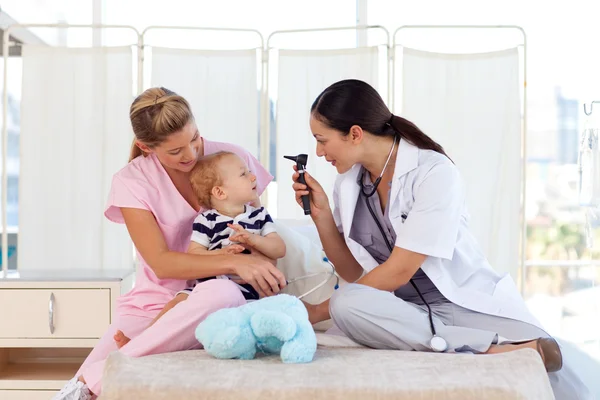 Young doctors attending to a baby — Stock Photo, Image
