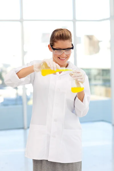 Beautiful scientist examining a test-tube — Stock Photo, Image